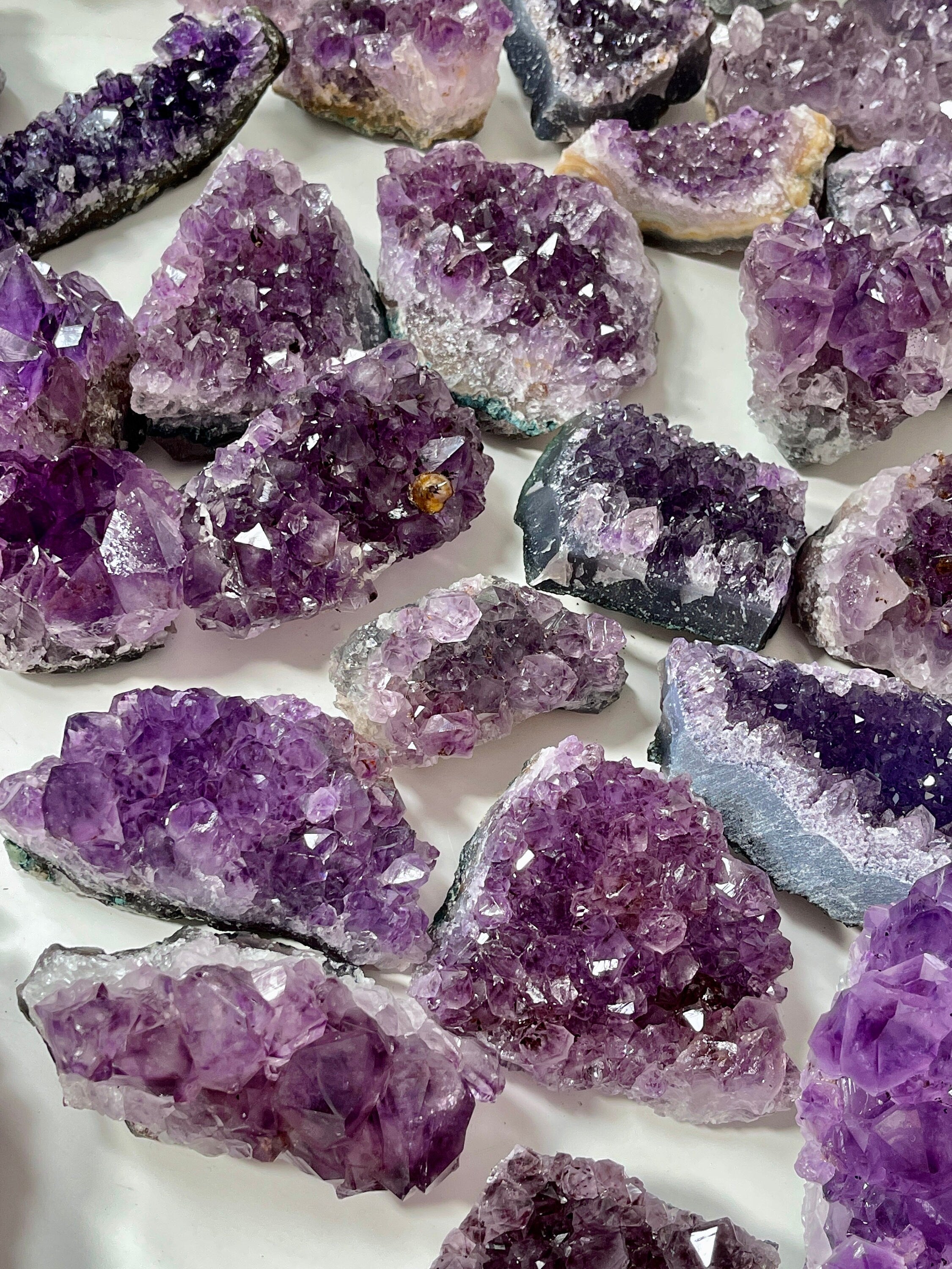 Collection of purple crystal formations on a white background