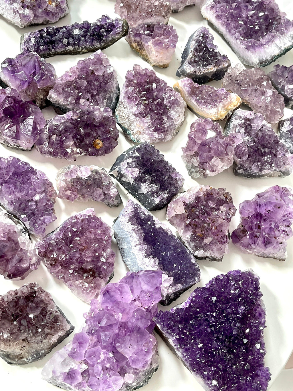 Collection of purple crystal rocks on a white background