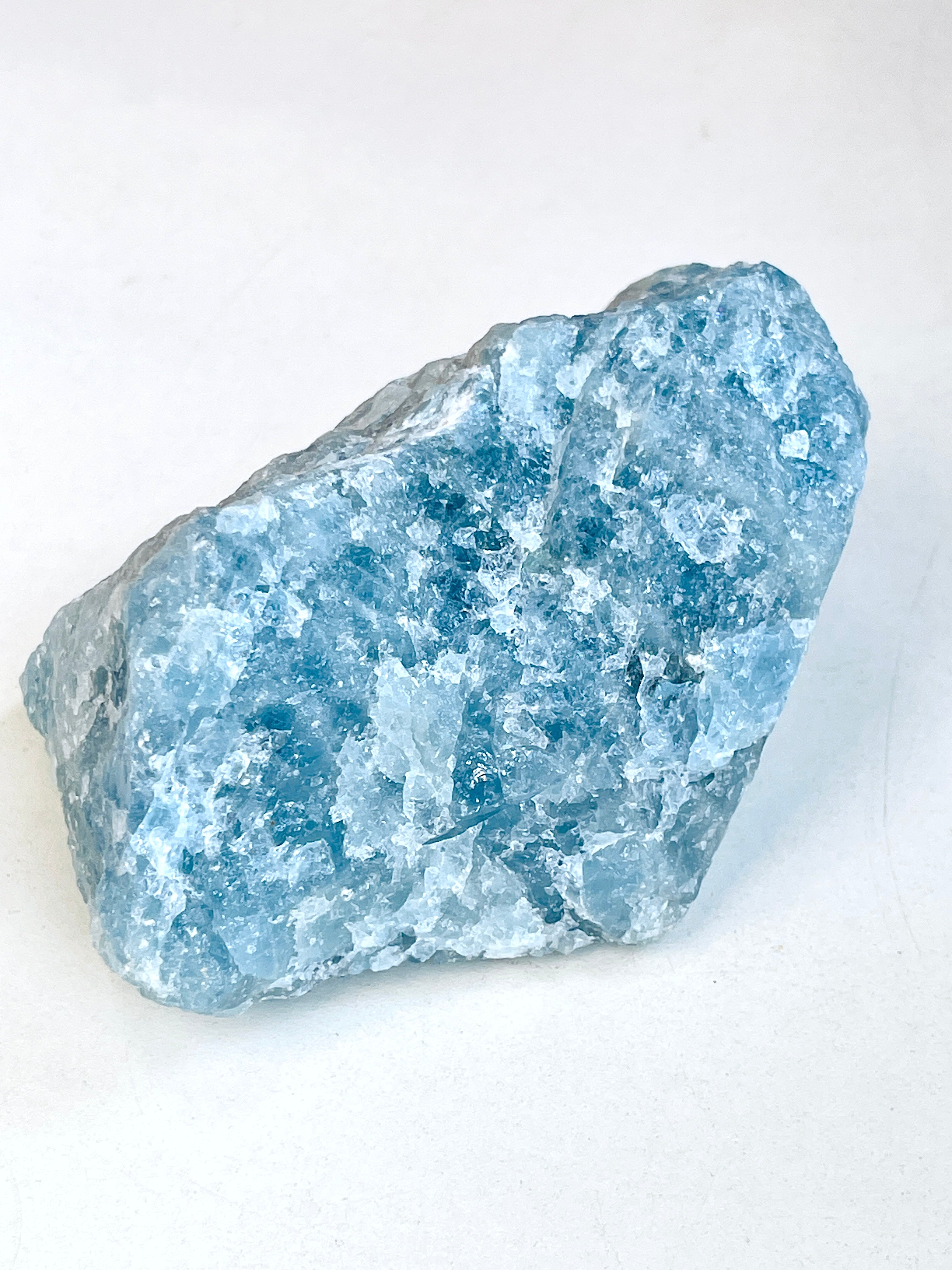 Blue aquamarine crystal rock on a white background