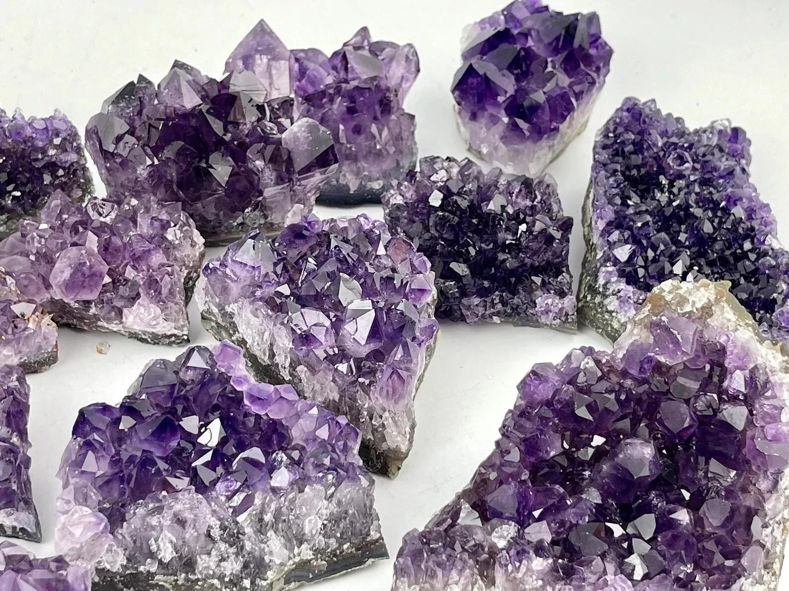 Deep Purple Amethyst crystal clusters on a white background
