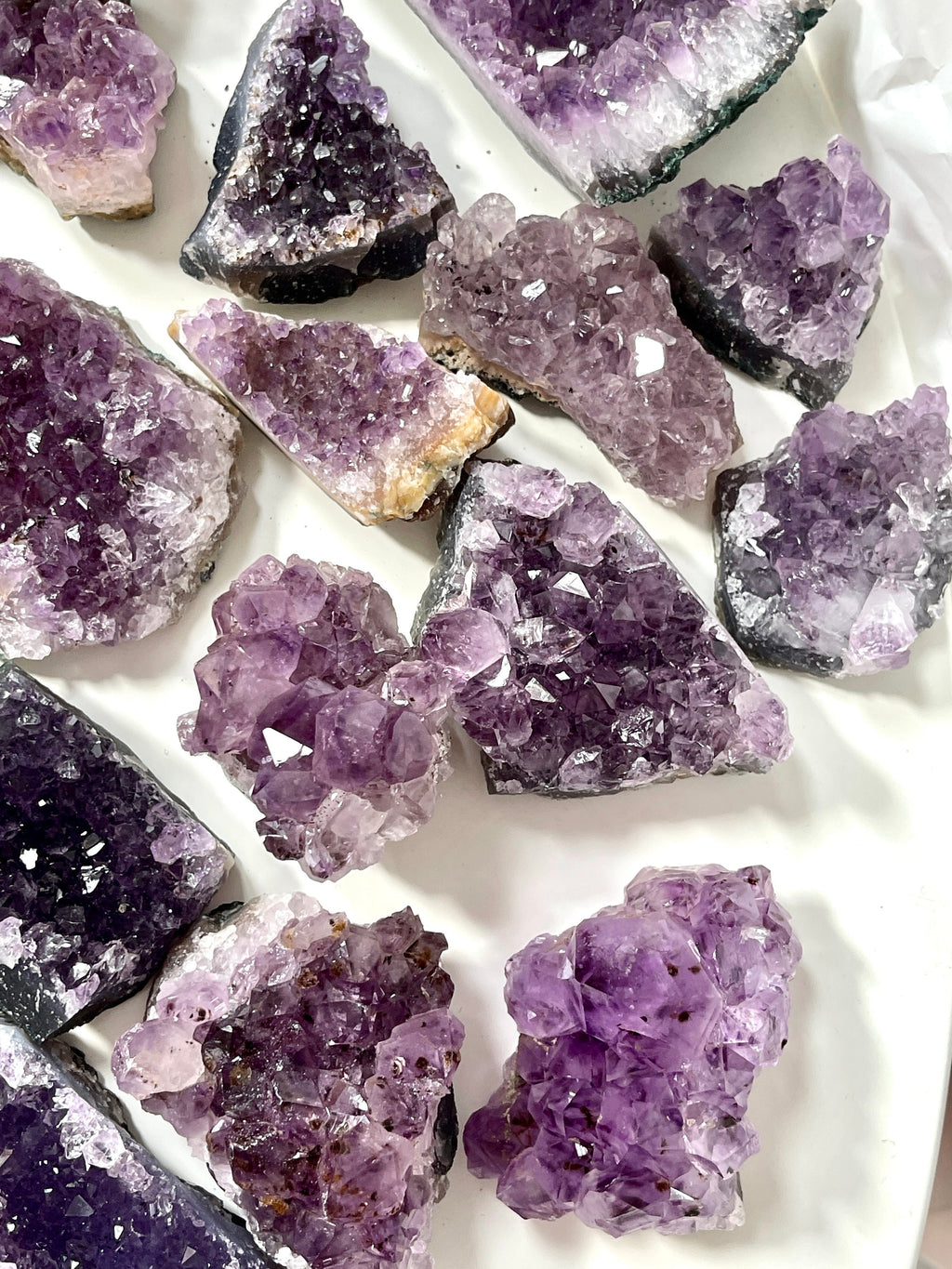 Amethyst crystal clusters on a white background