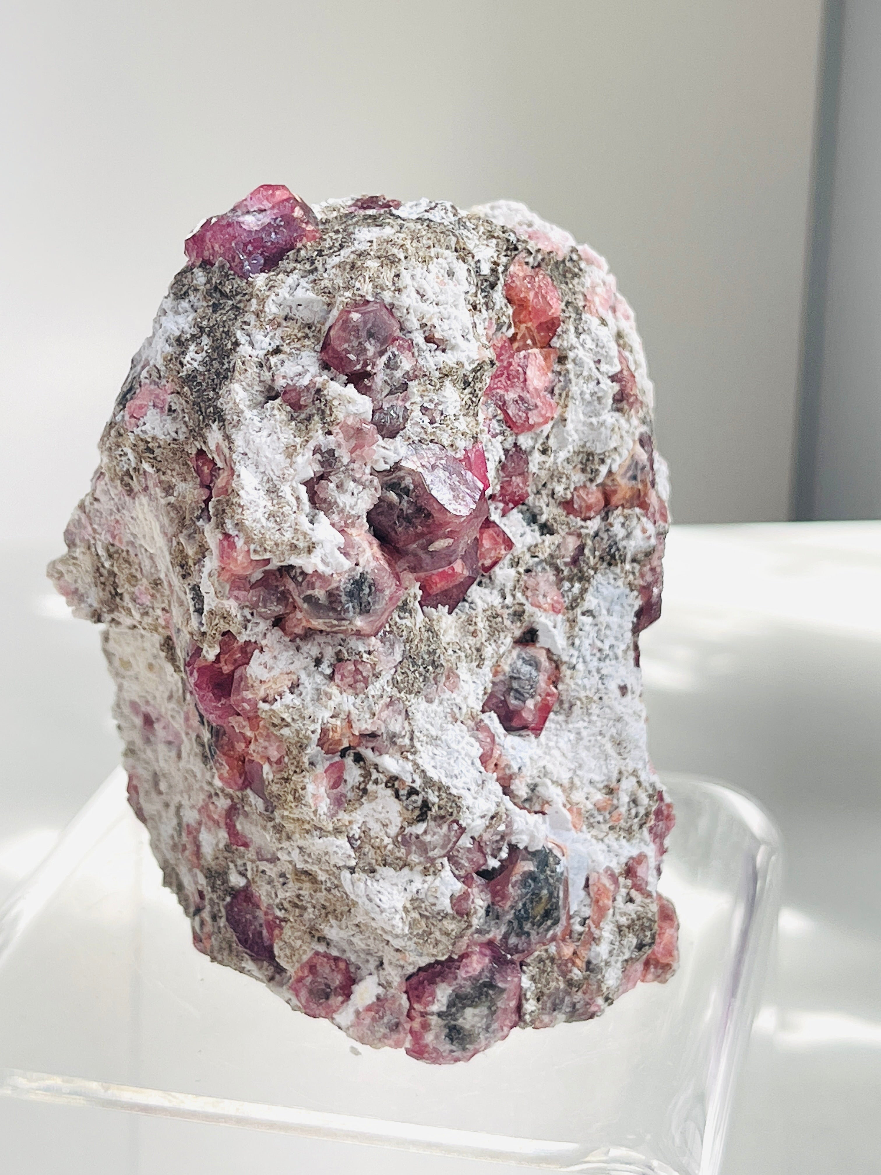 Mineral sample with pink and white coloration on a white background